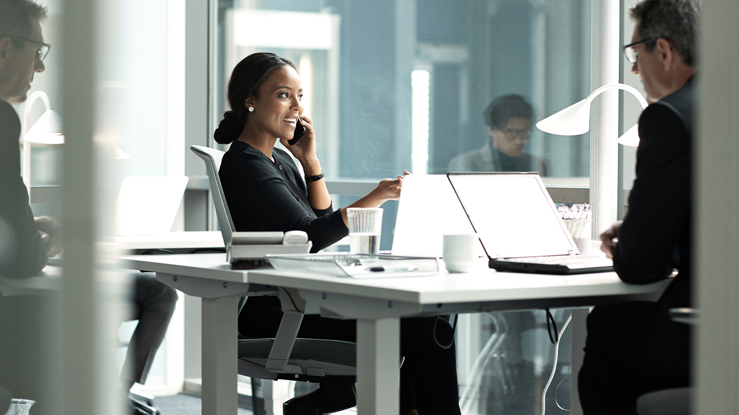 Woman on the phone in her office banner
